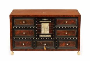 A 17TH-CENTURY ITALIAN WALNUT TORTOISESHELL, EBONY AND IVORY DECORATED TABLE CABINET