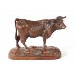 A 19TH CENTURY SWISS BLACK FOREST CARVED LINDEN WOOD COW POSSIBLY BY HUGGLER