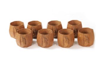 A GOOD SET OF EIGHT ROBERT 'MOUSEMAN' THOMPSON MEDIUM OAK SLIGHTLY ADZED SERVIETTE RINGS