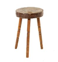 A 18TH CENTURY PRIMITIVE ELM STOOL