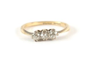 AN 18CT GOLD THREE STONE DIAMOND RING