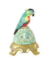 AN EARLY 20TH CENTURY ROYAL DOULTON ARTANDIA SPEAKER COVER MODELLED AS A PARROT