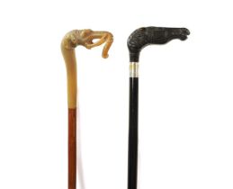 A 19TH CENTURY EBONISED WALKING CANE AND ANOTHER ELEPHANT’S HEAD WALKING STICK