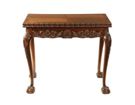 A GEORGE II STYLE CARVED MAHOGANY FOLD OVER CARD TABLE
