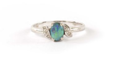 AN 14K WHITE GOLD AND BLACK OPAL SET LADIES RING