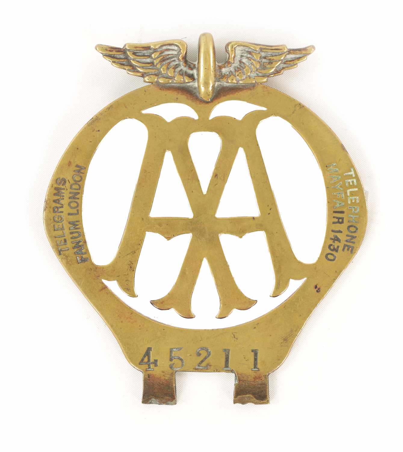 AN EARLY AA BRASS CAR BADGE