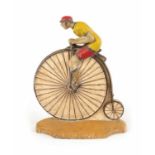 A RARE 19TH CENTURY CAST IRON PAINTED DOORSTOP FORMED AS A CYCLIST MOUNTED ON A PENNY FARTHING