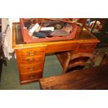 Oak Leather topped desk of 9 drawers with brass drop handles