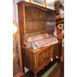 Large Oak panel backed dresser with cupboard base over straight stretcher and barley twist legs