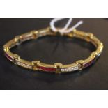 A Fine 18ct Gold Ladies Ruby & Diamond channel set Bracelet with 12 bars of alternating Ruby (3ct