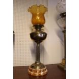 Edwardian Brass Reservoir Oil Lamp with Amber glass shade terminating on ceramic base