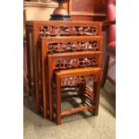 Nest of 4 Chinese Hardwood tables with pierced floral frieze