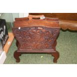 Oak Carved magazine rack with floral decoration supported on scroll feet