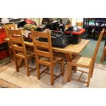 Pine Rectangular dining table on cruciform supported base and a set of 6 Rush seated chairs