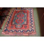 Red ground 20thC Rug with tassel ends 150 x 120cm