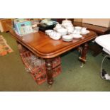 Good quality extending Mahogany dining table with two leaves and brass casters