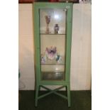 Metal green painted glazed display cabinet on cruciform supported base
