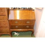 Edwardian fall front bureau with brass drop handles over curved legs