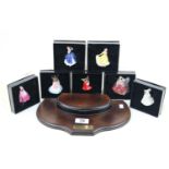 Set of 6 Boxed Royal Doulton miniature figurines on wooden stand