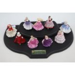 Collection of 9 Royal Doulton Miniature Figurines on wooden stand