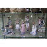 Collection of Seven Nao figures inc. Newspaper Boy, Girl with Violin etc