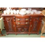 Edwardian serpentine fronted sideboard with brass drop handles on ball feet