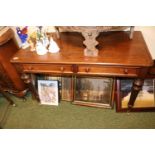 Late Victorian Mahogany desk of 2 drawers on turned and fluted legs and brass casters