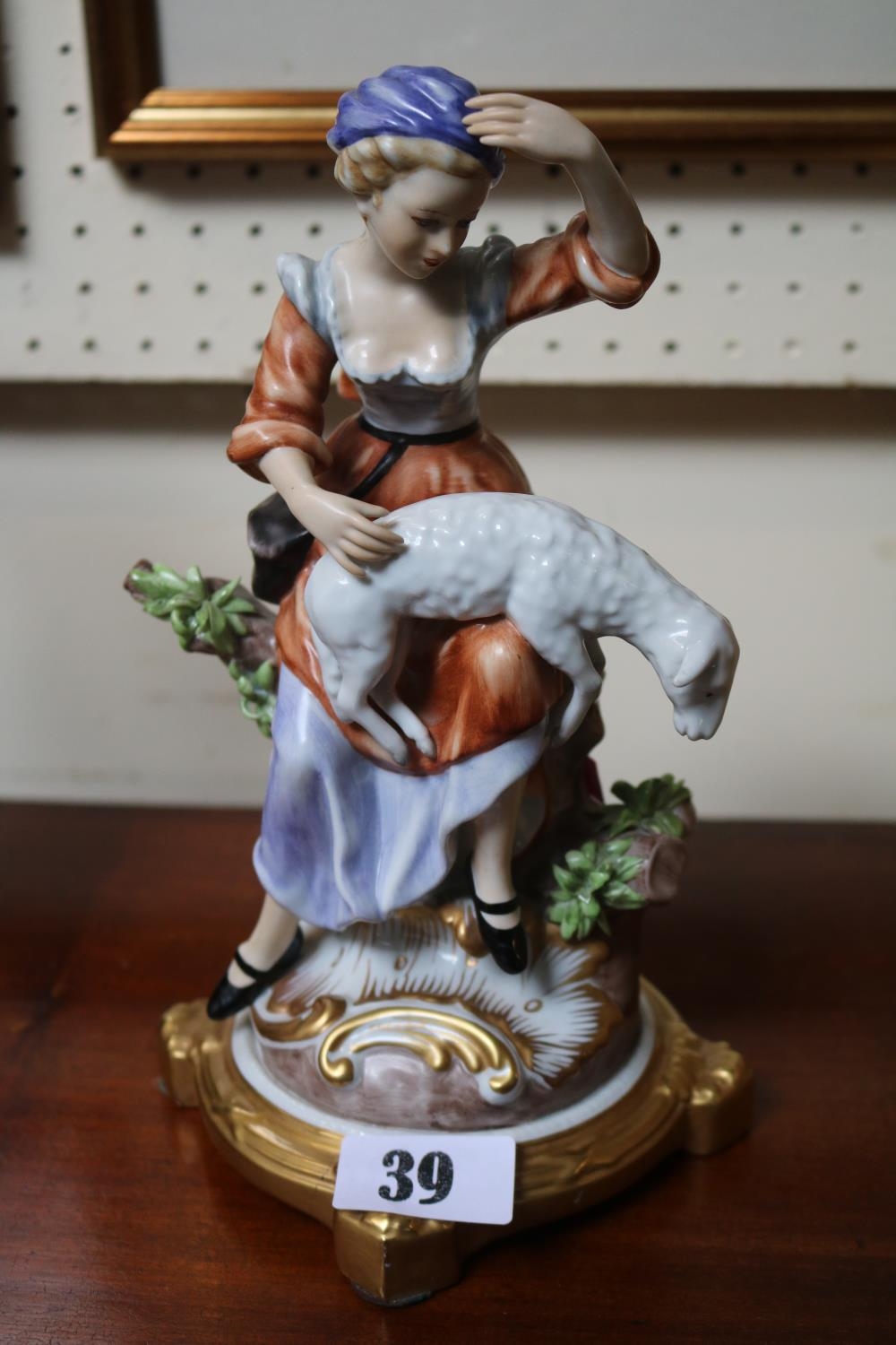 Good Quality European figurine of a shepherdess with Gilt base, Cross swords mark to base. 24cm in