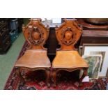 Pair of Oak Carved Shield back hall chairs on scroll feet