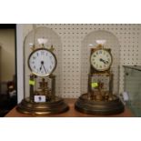 Gustav Becker Brass Anniversary clock under glass dome and another Brass Anniversary clock with