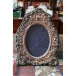 20thC Silver embossed Oval photo frame with Cherub decoration on Hinge