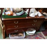 Edwardian Chest of 2 over 2 drawers with brass drop handles and tapering legs terminating on casters