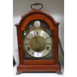 F W Elliott Walnut cased bracket clock with roman numeral dial and matching key