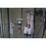 Collection of Nao and Lladro figures of Nuns, Choir Boys and a girl with candlestick (4)
