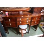 19thC Mahogany bow fronted sideboard with applied lions head brass handles over tapering legs