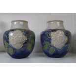 Pair of Royal Doulton White rose decorated squat vases with impressed marks to base.15.5cm in Height