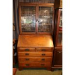 Edwardian Fall Front bureau bookcase with fitted interior and brass drop handles over bracket feet