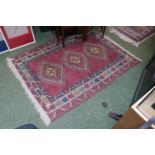 Red Ground Rug with 3 central medallions 166cm in length