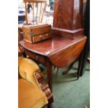 Edwardian Mahogany drop leaf table on tapering legs and brass casters with circular drop handles
