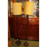 Pair of Mid Century standard lamps with tole painted stems under cylindrical shades