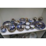 Large collection of 19thC Blue and White Willow pattern tableware with gilded banding