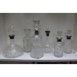Good collection of Silver Rimmed Cut Glass decanters and a etched glass African design decanter