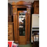 Edwardian Satinwood Single wardrobe with mirrored door inset metal panels and shaped pediment