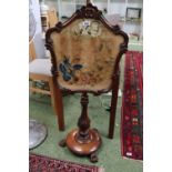 Early 19thC Rosewood veneered Fire screen with embroidered panel over circular base and Paw feet