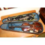 Cased Violin with paper label 'Repaired by Peter Young' with two bows and Rosewood veneered case