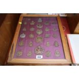Framed collection of assorted Copper Military Cap Badges inc. inc Canadian, Hussars, 48th Highlander