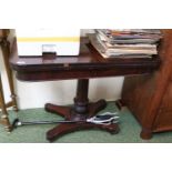 Victorian Mahogany fold over card table with turned stem over trefoil base