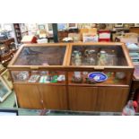 Large Glazed Museum display Cabinet with cupboards to base mounted on wheels with lights to interior