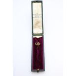 Ladies 9ct Gold Ruby set scroll stick pin in fitted case