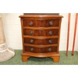 Serpentine chest of 4 drawers with metal drop handles over bracket feet